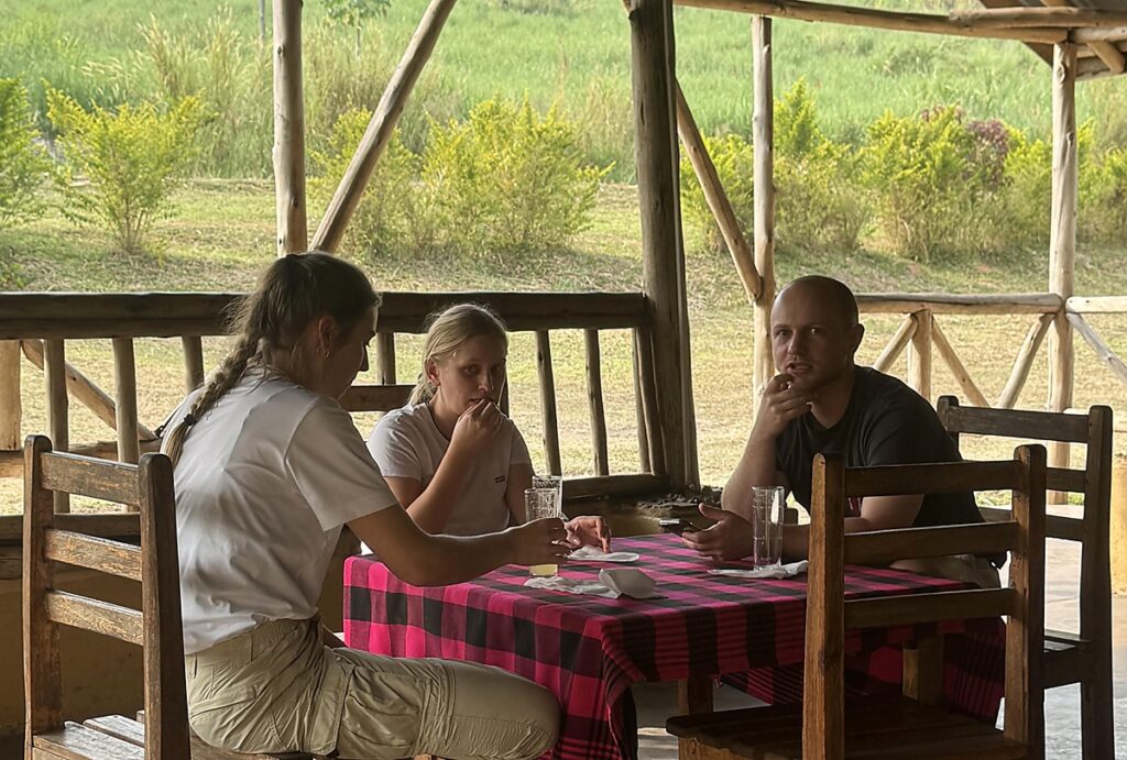 Guests enjoying a meal at Nguse River Camp in western Uganda